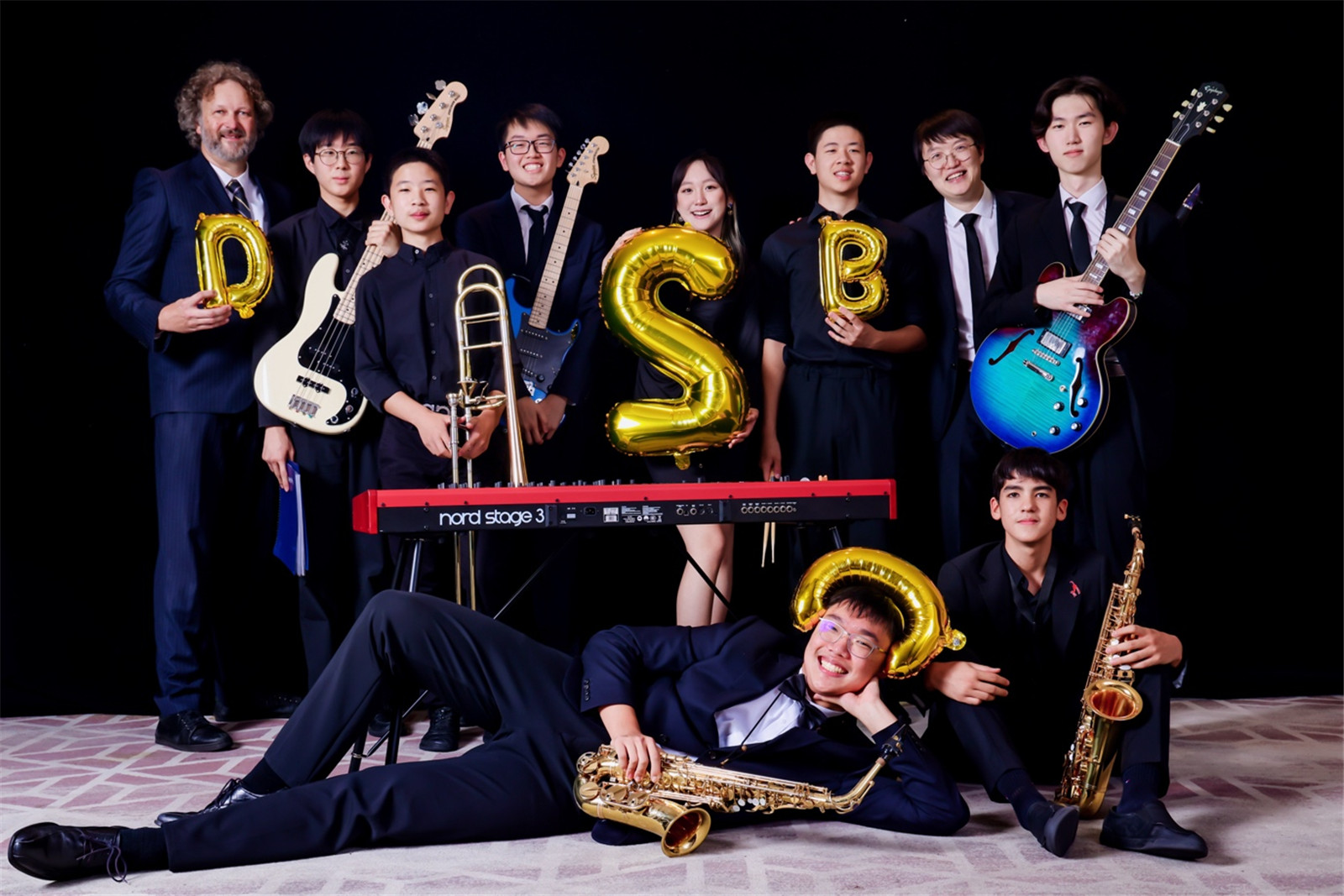 Eddy and the jazz band strike a funny pose after performing at the Music & Drama Awards Ceremony