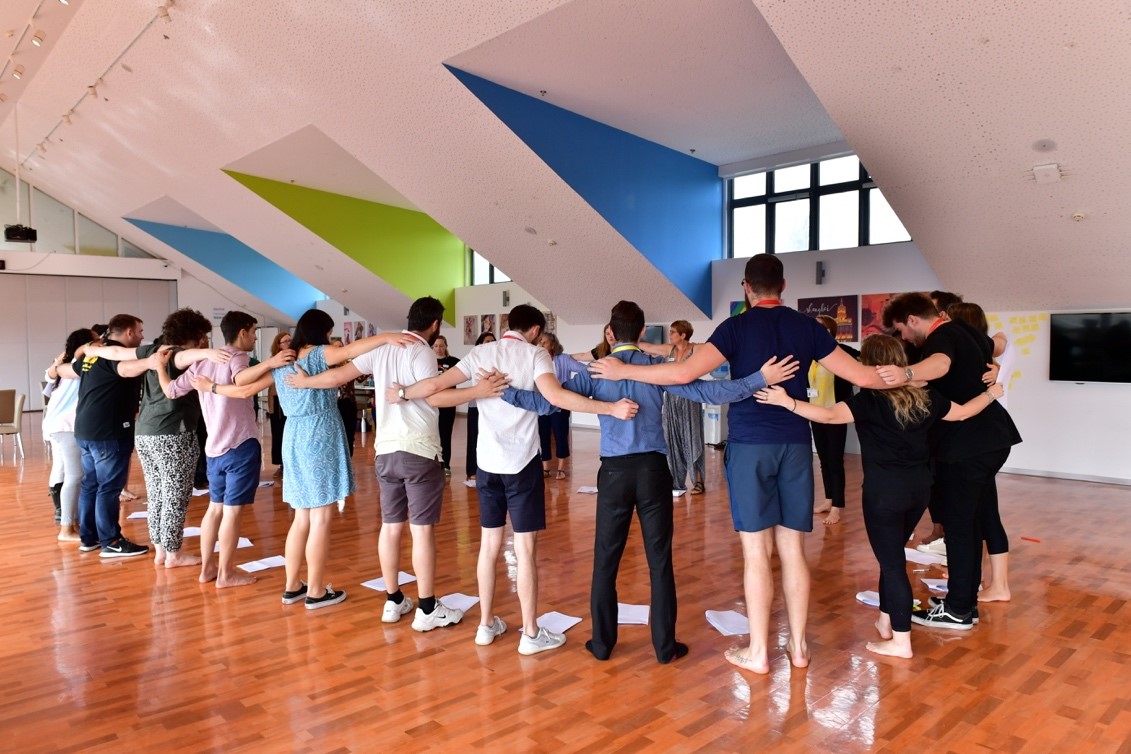 Dulwich College International staff huddle together in a RSC Education led workshop